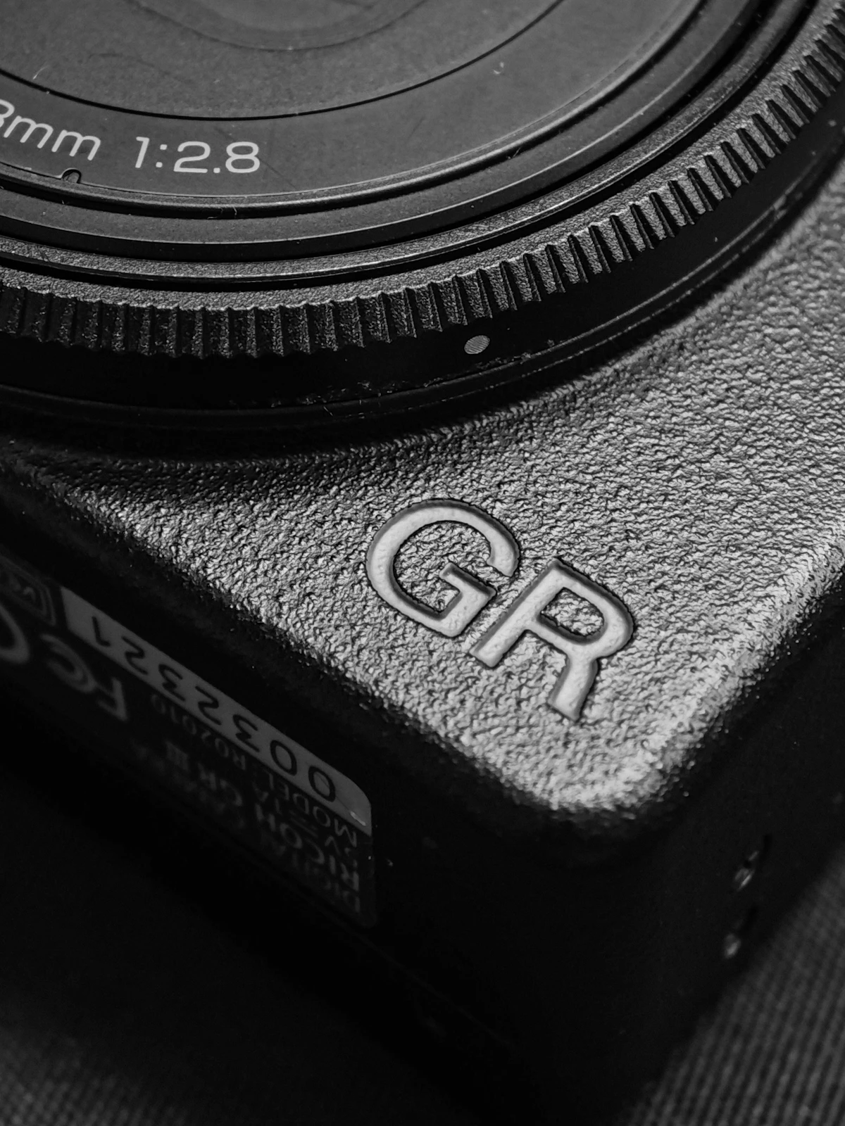 Close-up of a textured camera body with an embossed logo