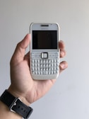 a person holding a cell phone in their hand