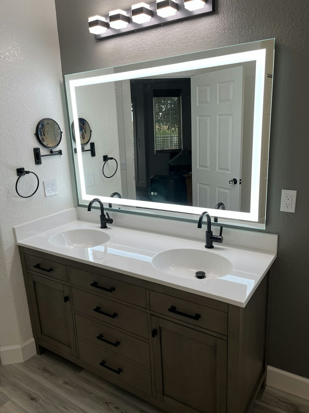 a bathroom with two sinks and a large mirror