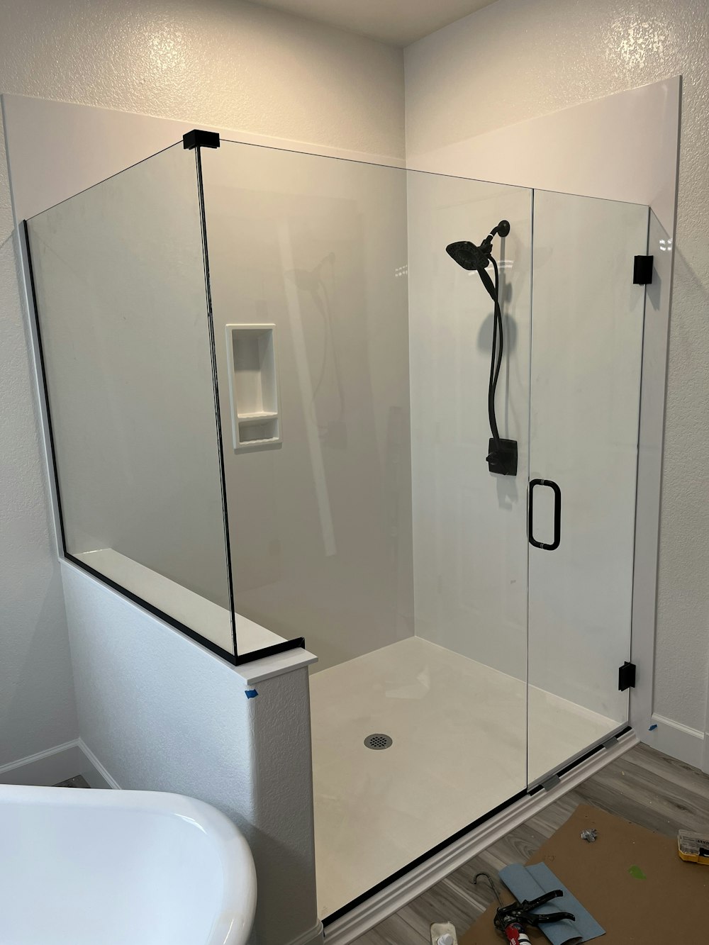 a bathroom with a glass shower door and a tub