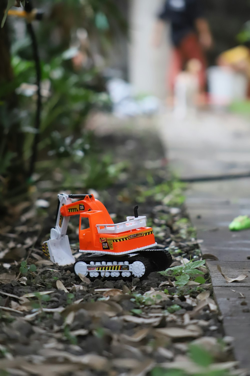 a toy bulldozer is sitting on the ground