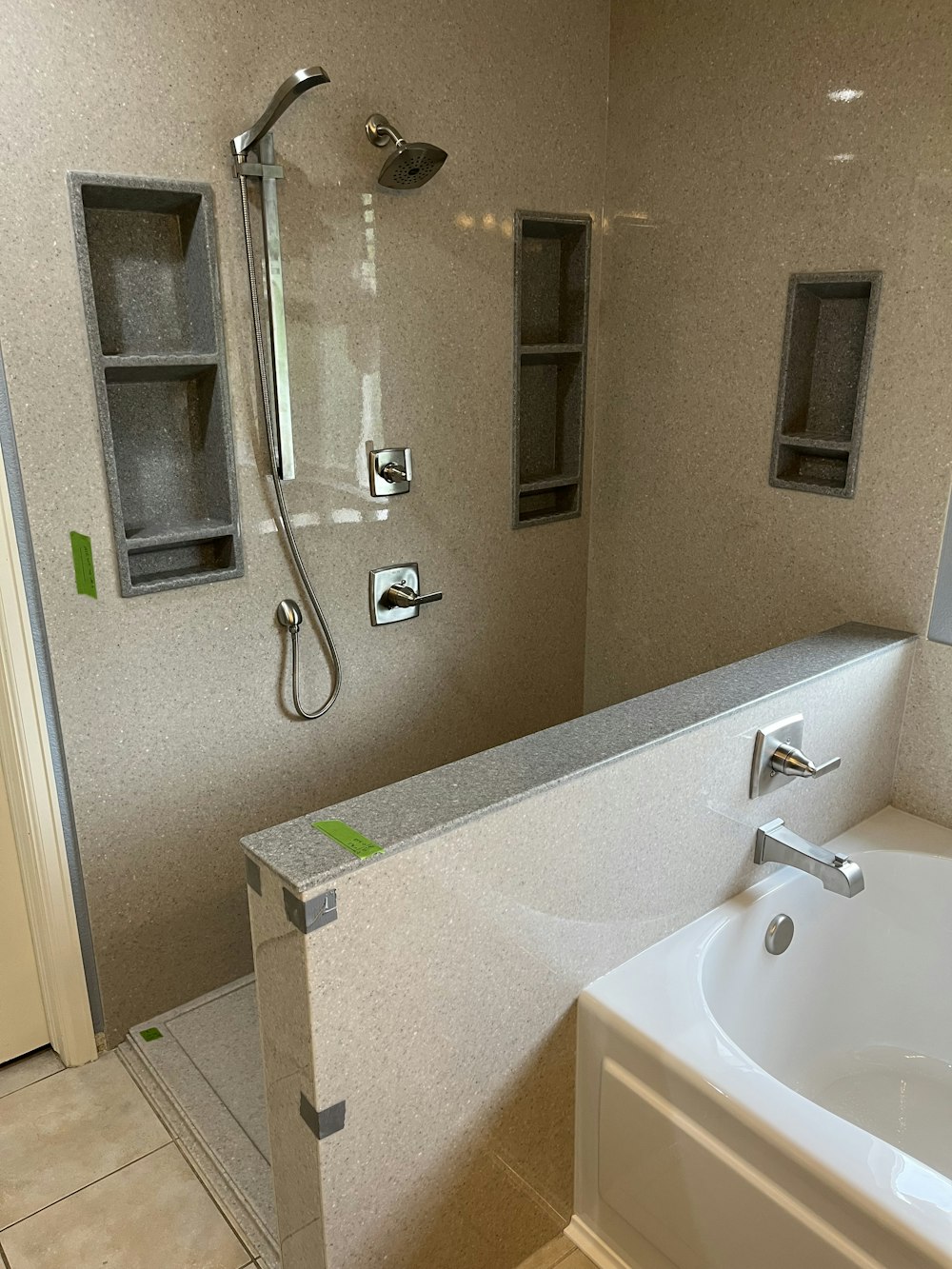 a bathroom with a sink, shower, and bathtub