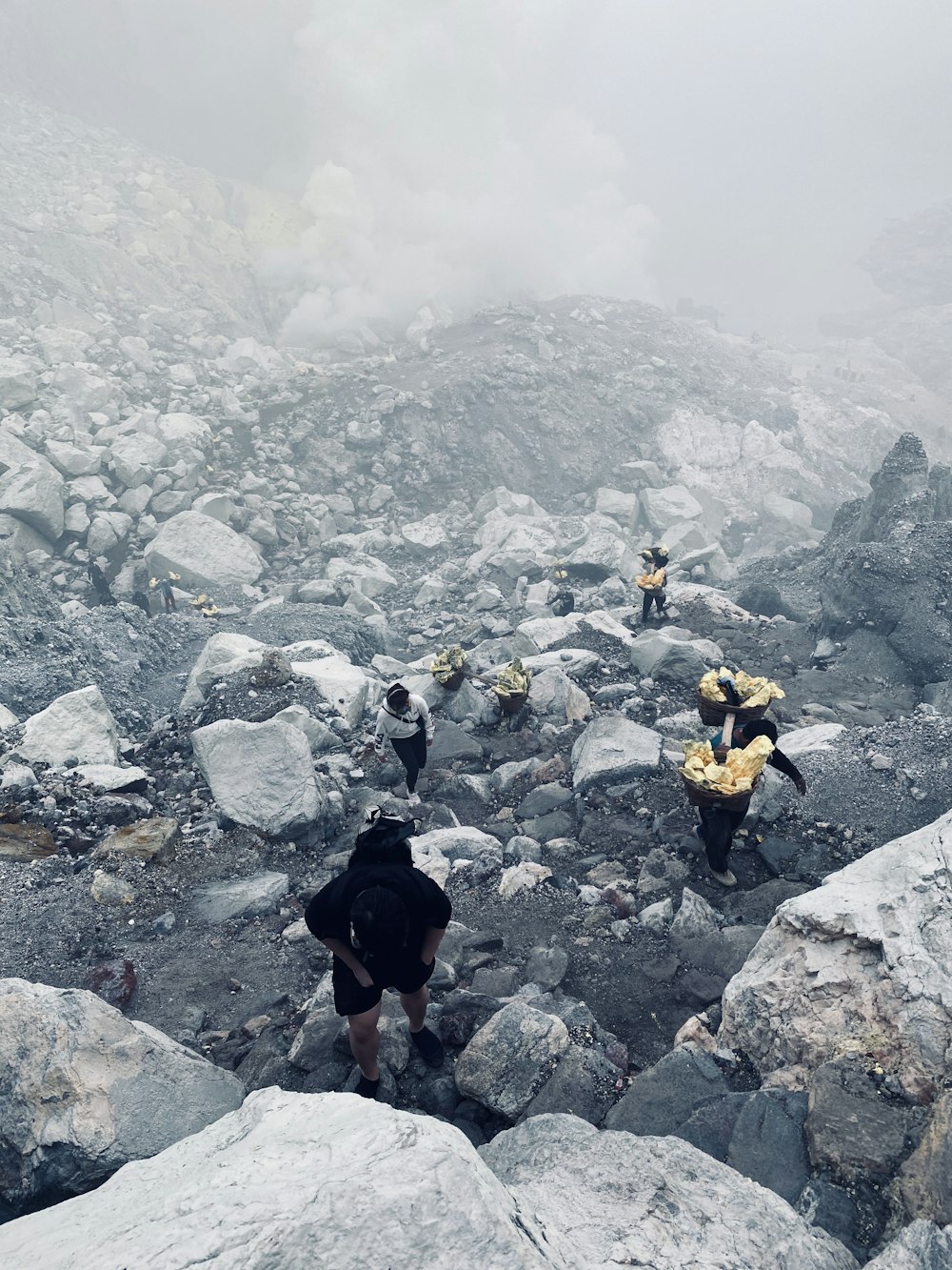 a group of people hiking up a rocky mountain