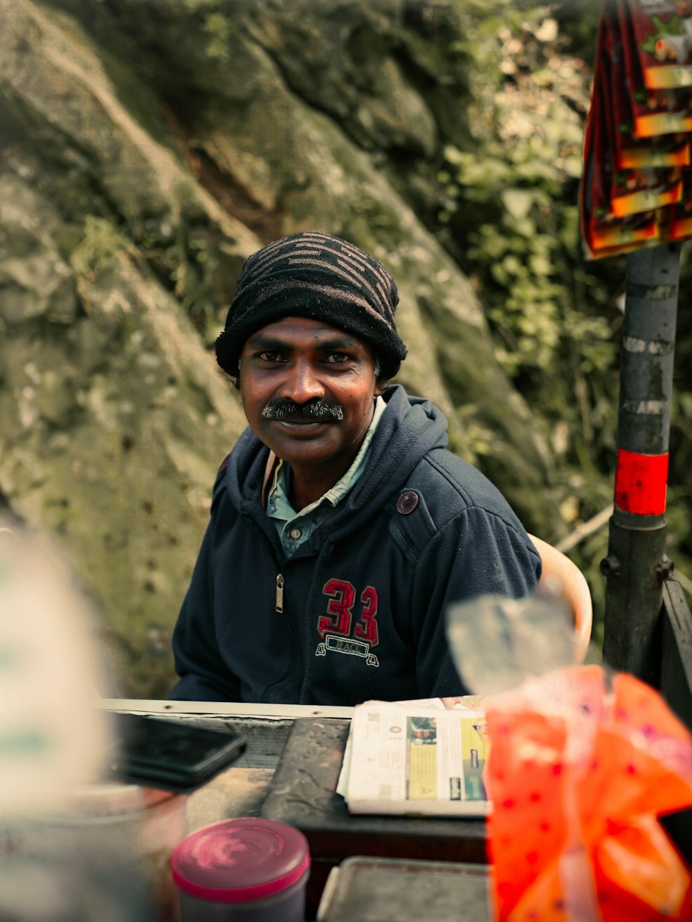 a man with a mustache sitting at a table