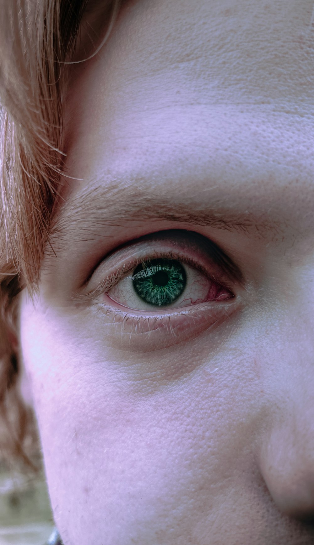 a close up of a person with green eyes