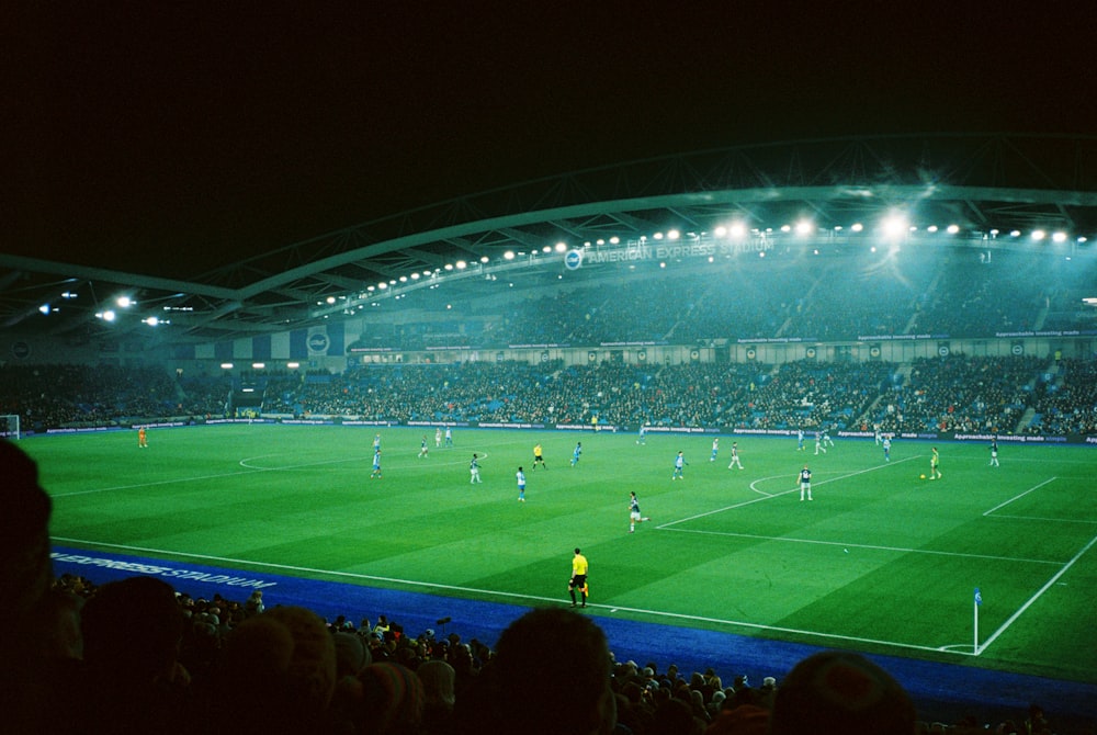 Un partido de fútbol en un estadio por la noche