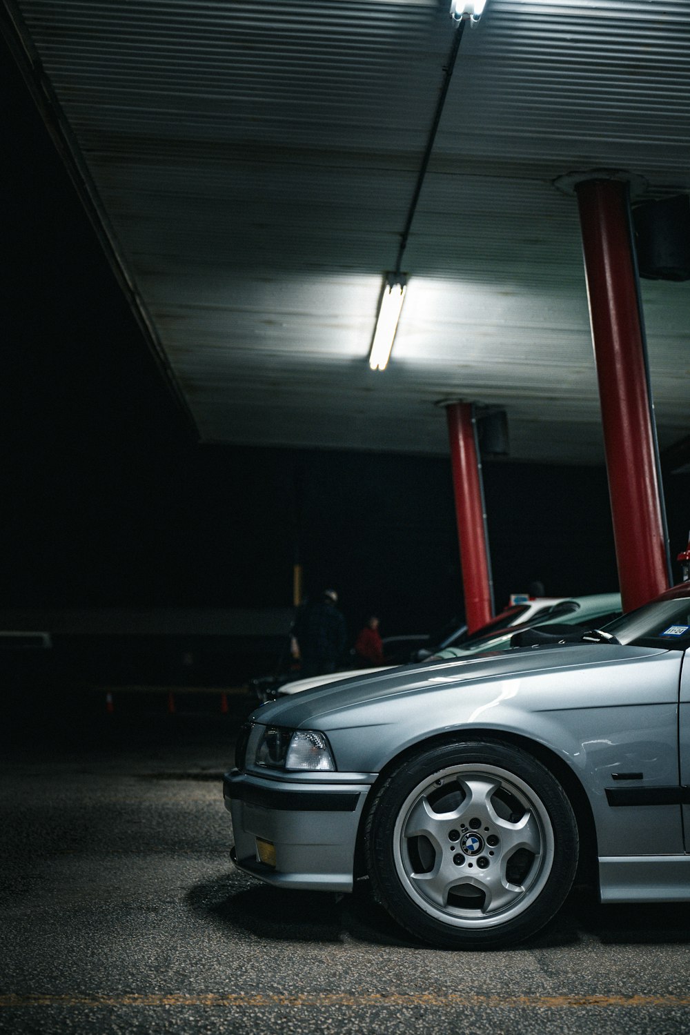 a silver car parked in a parking garage