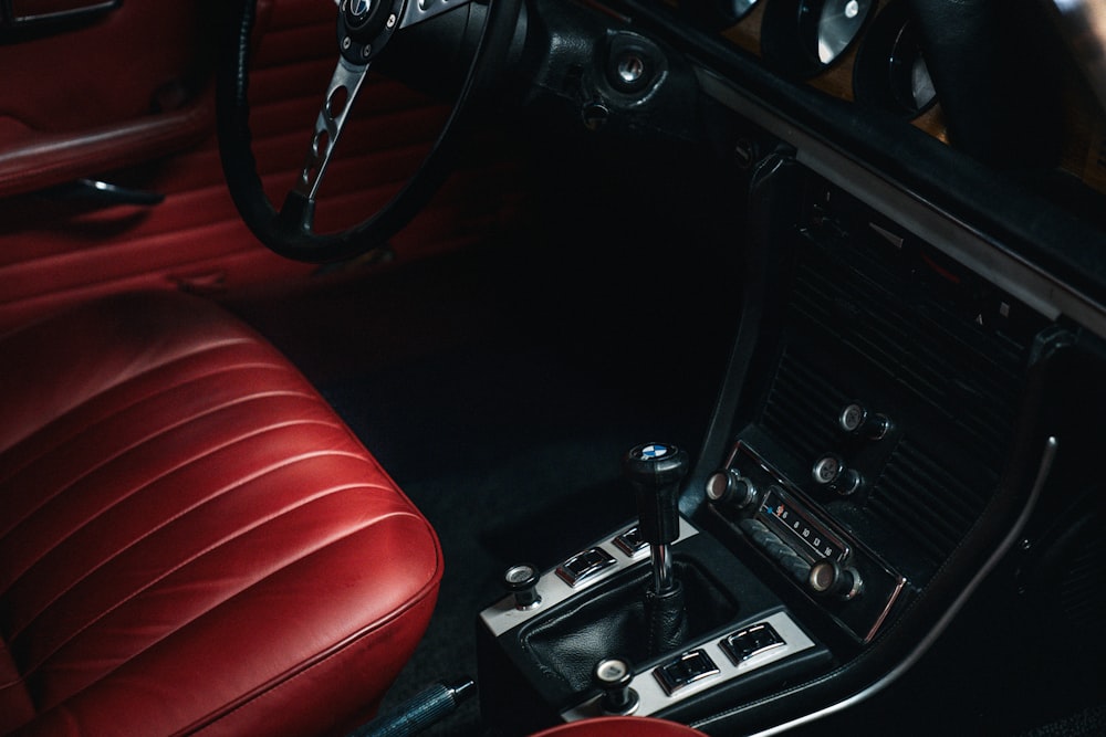 the interior of a car with red leather seats