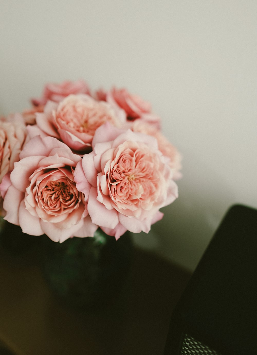 a vase filled with pink flowers on top of a table