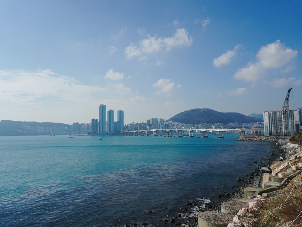 a body of water with a city in the background