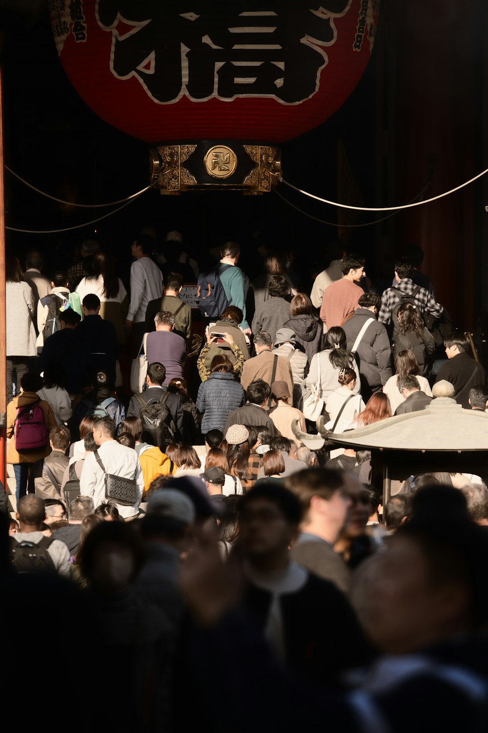 a crowd of people standing around each other