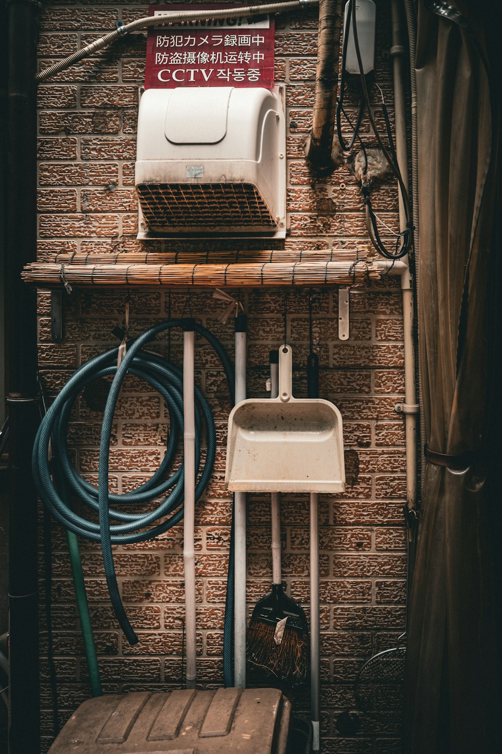 a brick wall with a bunch of pipes and a sink