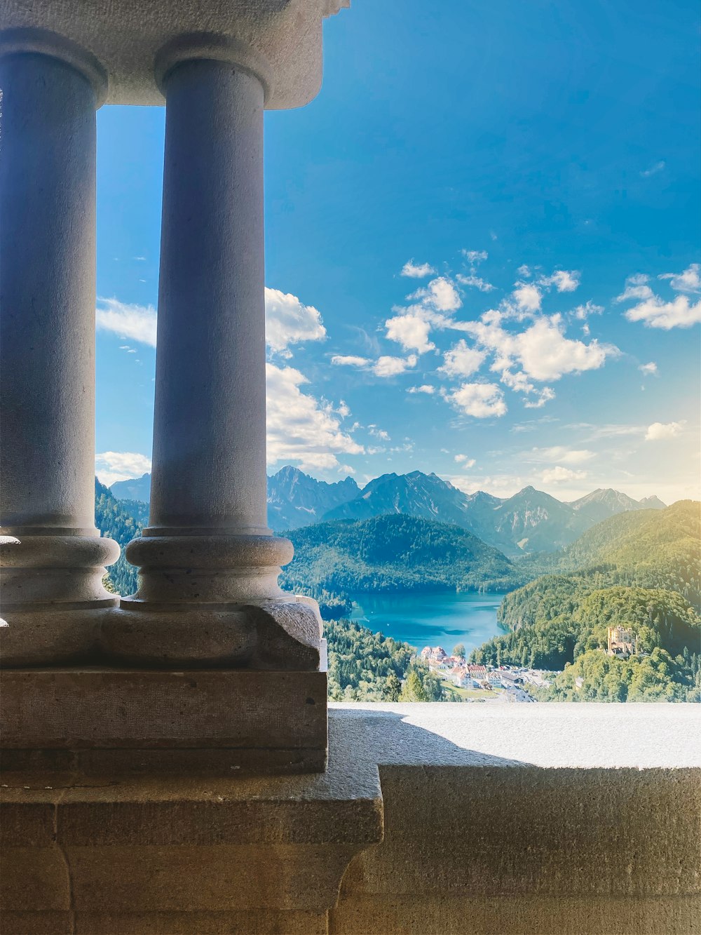 a view of a lake and mountains from a balcony