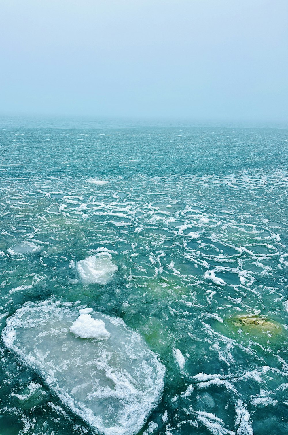 a large body of water with ice floating on top of it