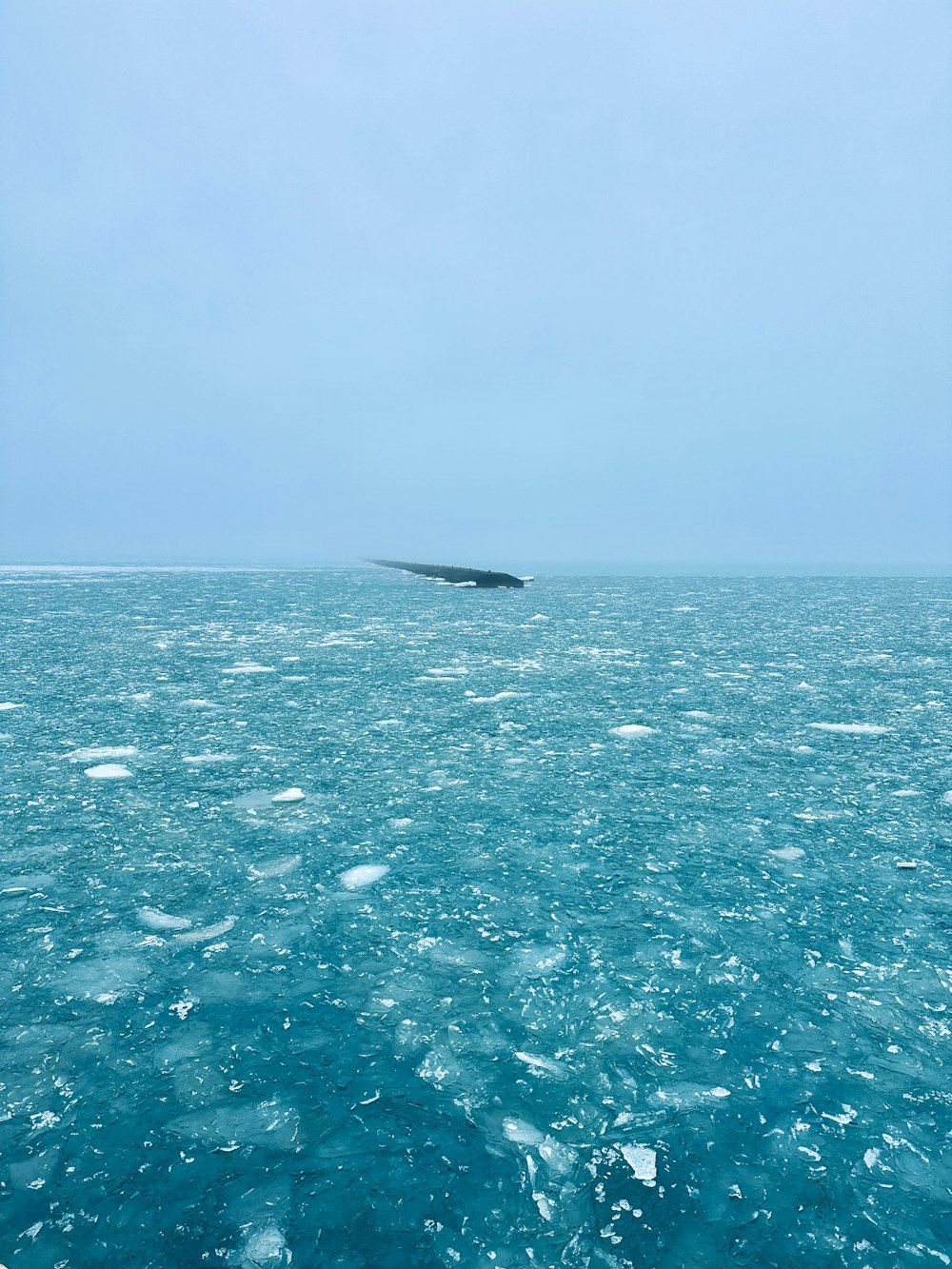 a boat floating on top of a large body of water