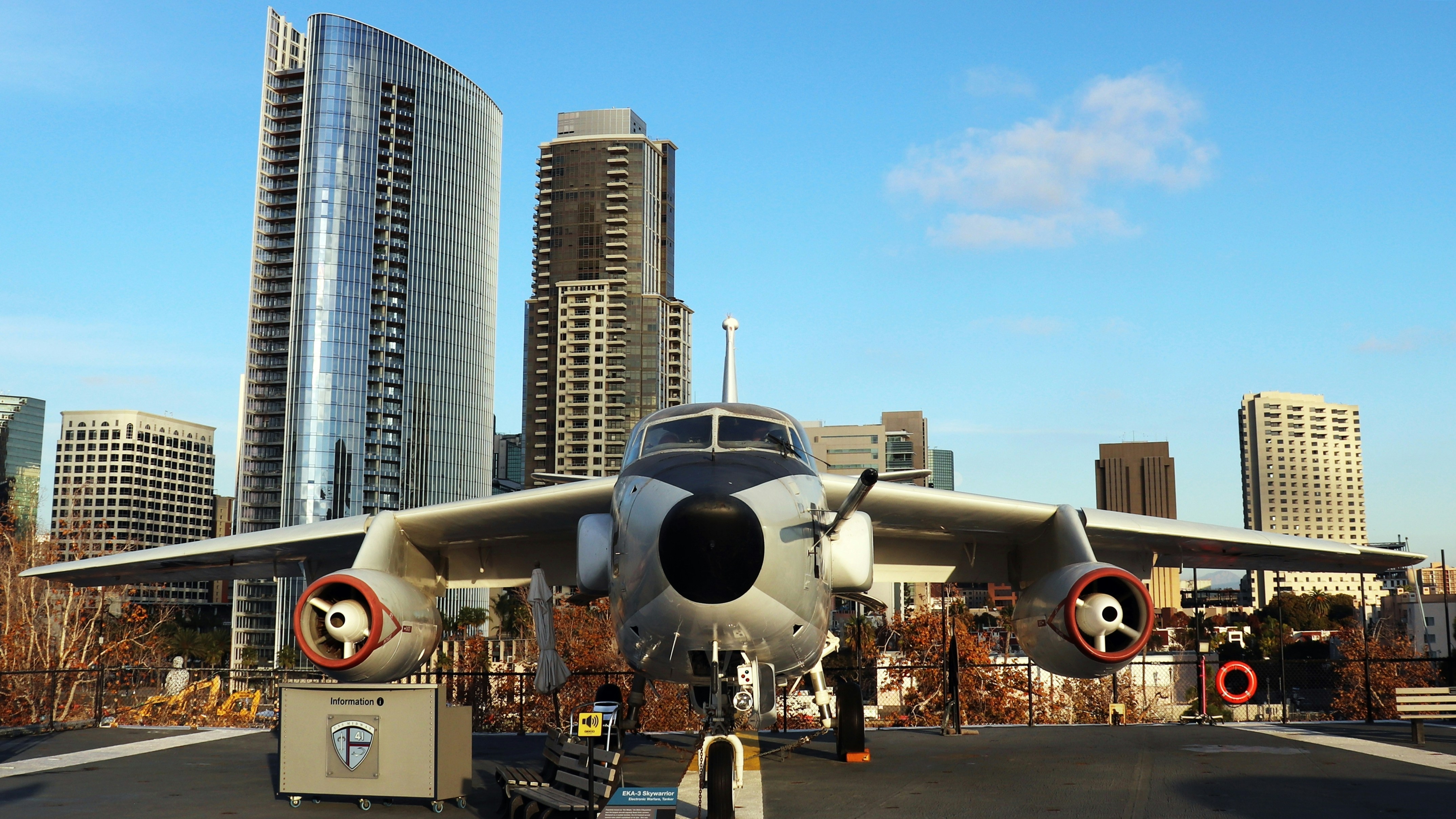 a plane parked on a runway in front of a city