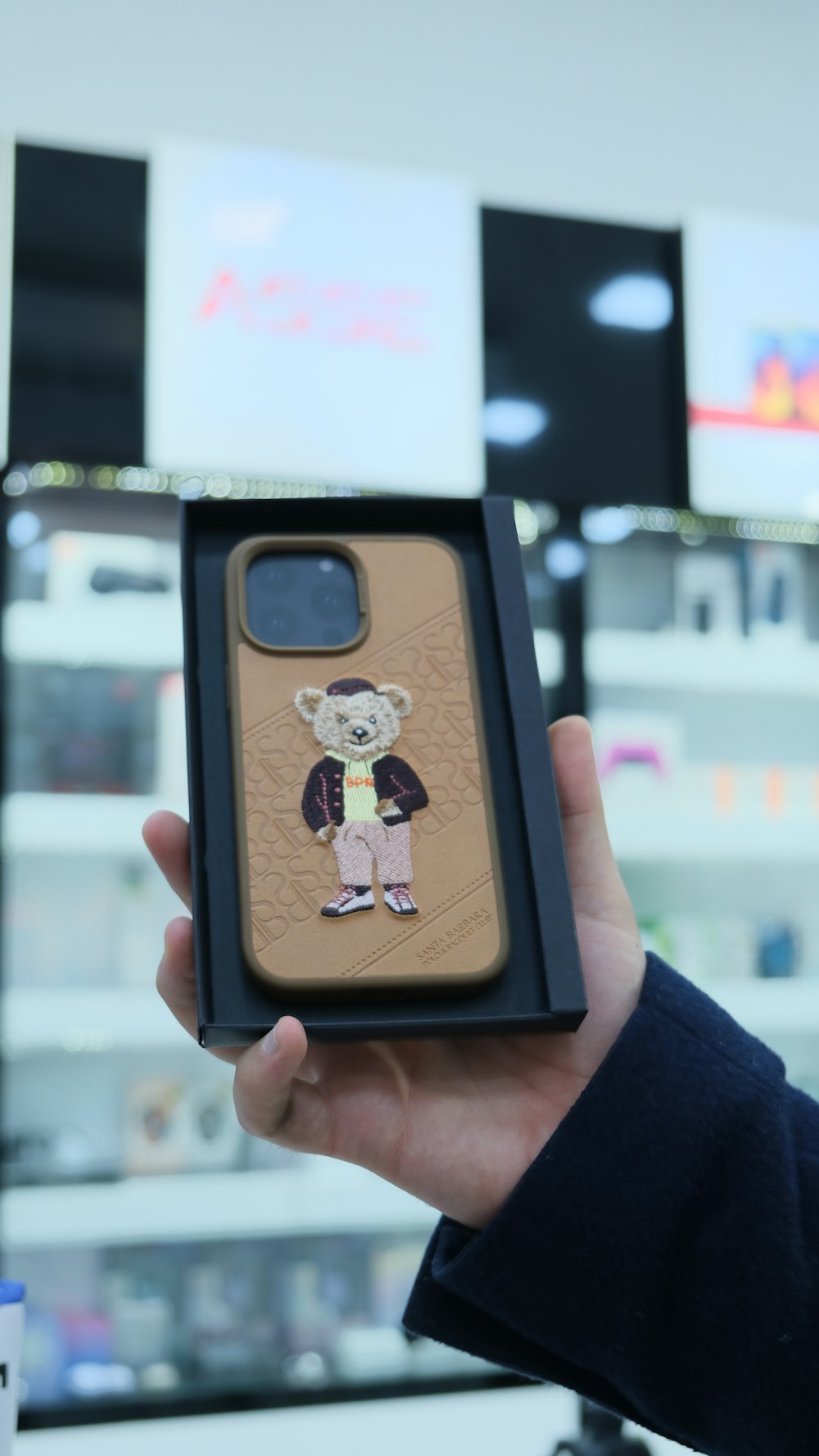 a person holding up a case with a picture of a monkey on it