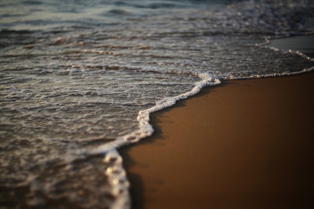 a close up of a wave on a beach