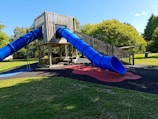 a playground with a slide and a play structure