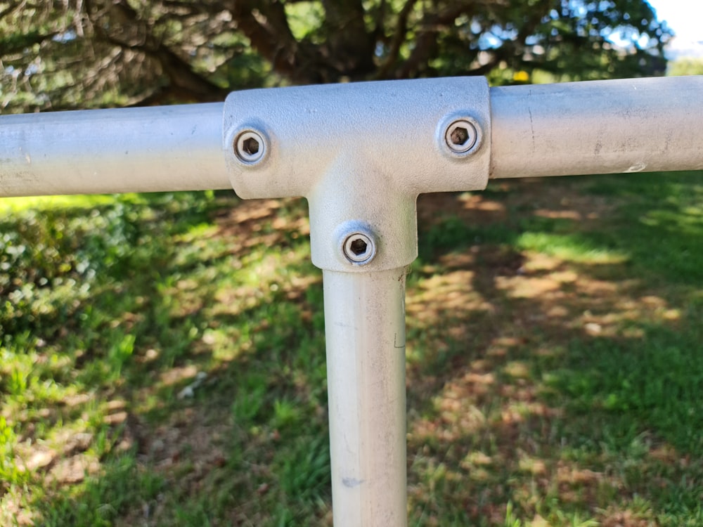 a close up of a metal rail in the grass