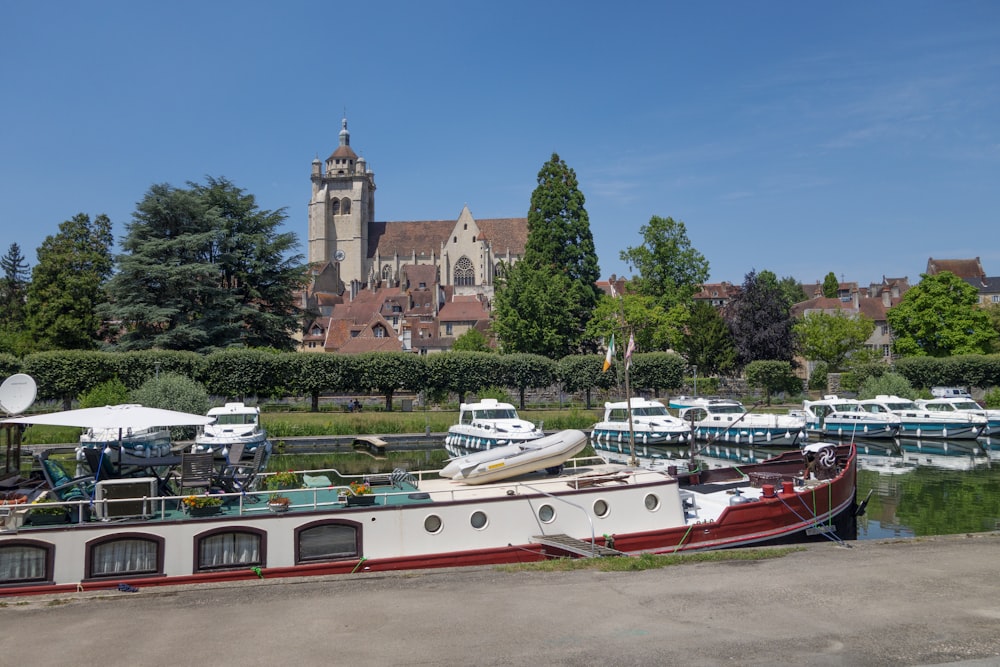 a boat is docked at a dock in front of a church