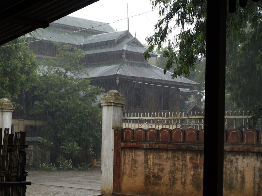 a building with a fence and a gate in the rain