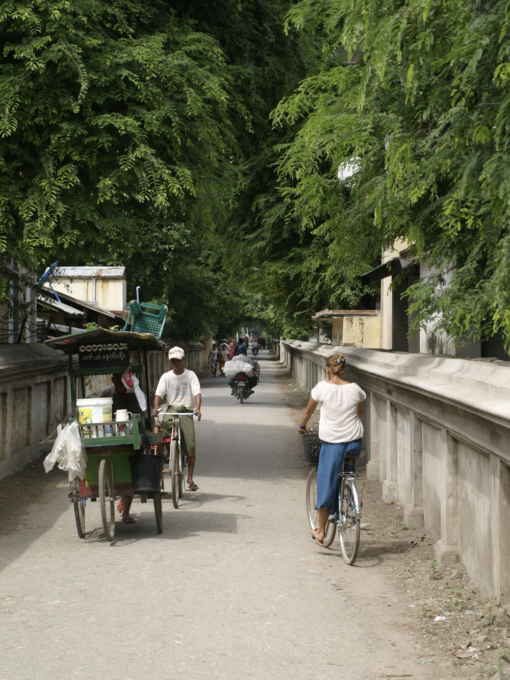 a man riding a bike down a dirt road