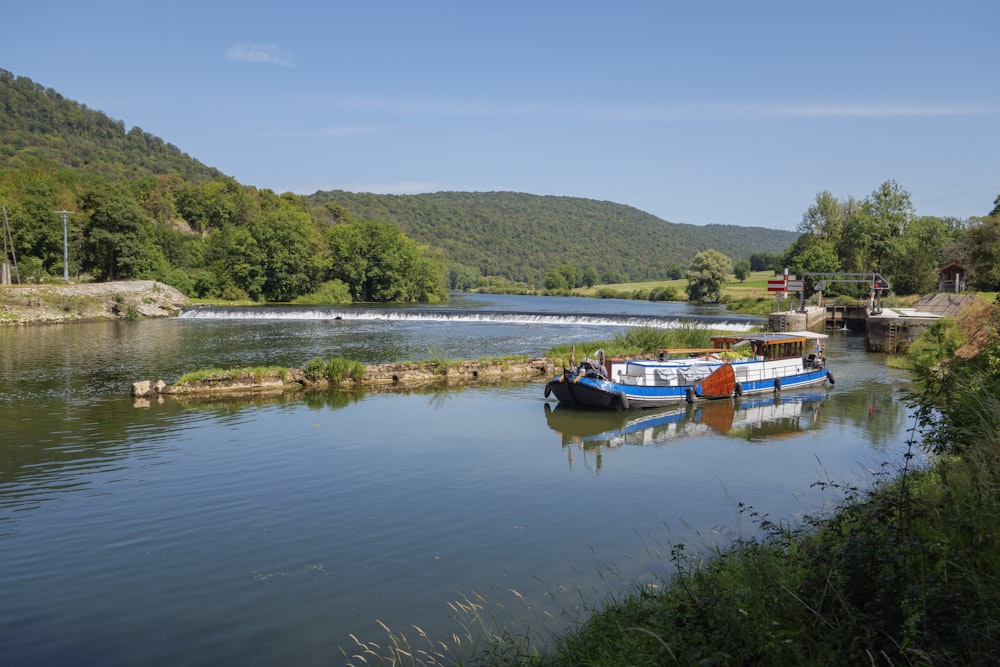 a couple of boats floating on top of a river