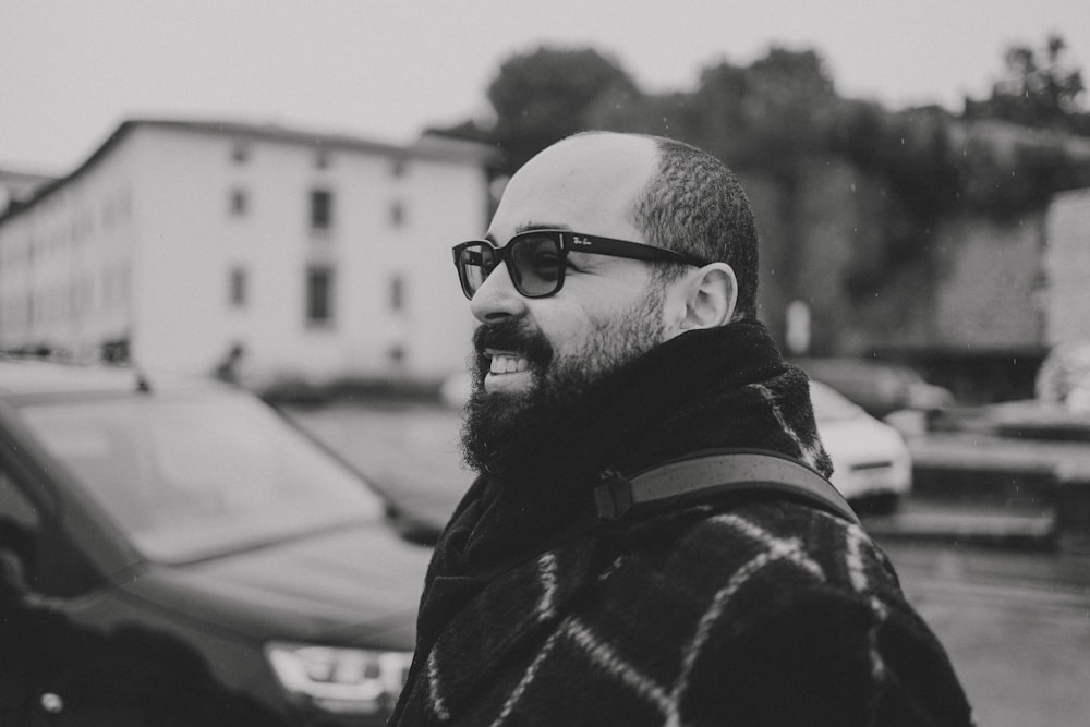 a man with a beard wearing sunglasses and a coat