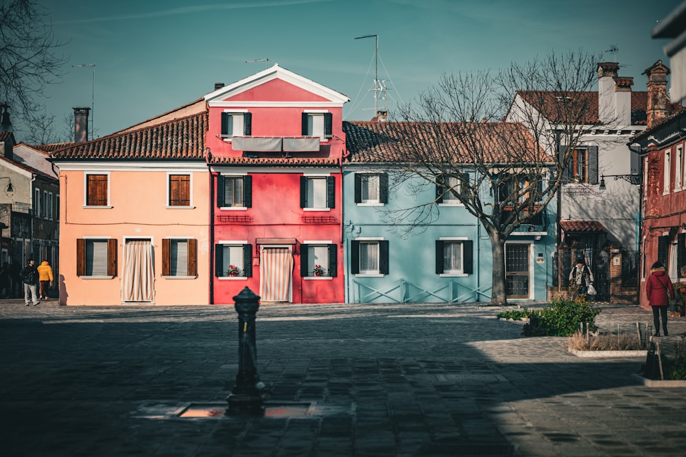 a row of colorful houses on a cobblestone street