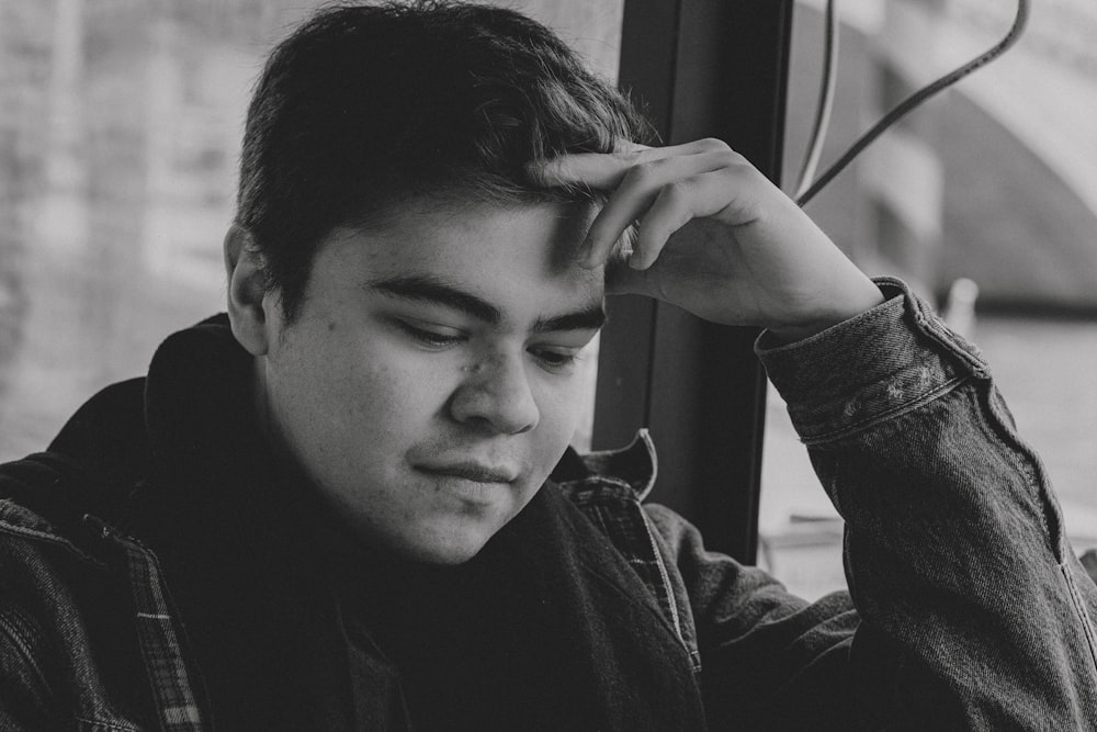 a black and white photo of a young man