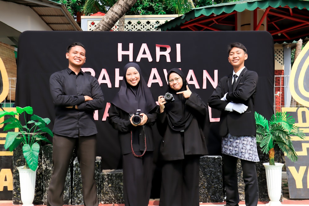 a group of people standing in front of a sign