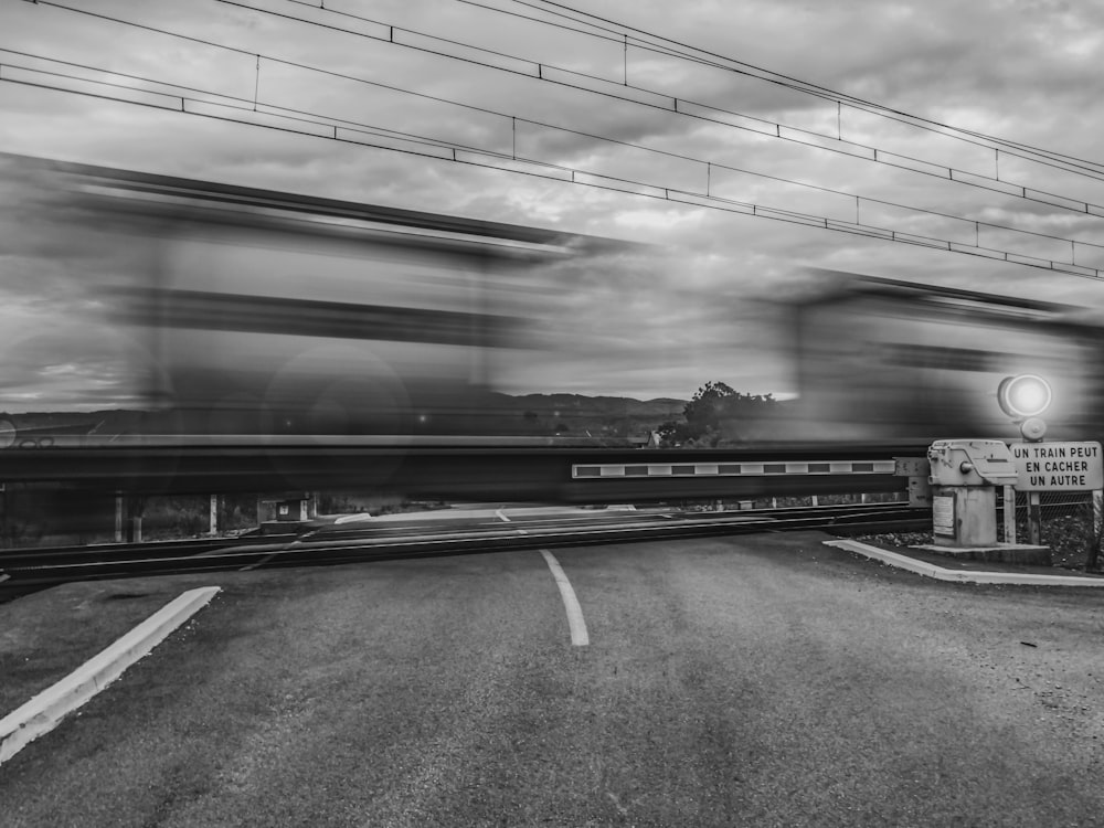 a black and white photo of a train going by