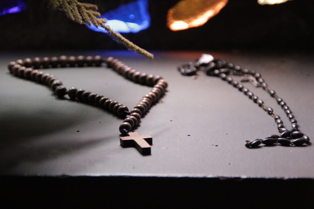 a rosary and a cross on a table