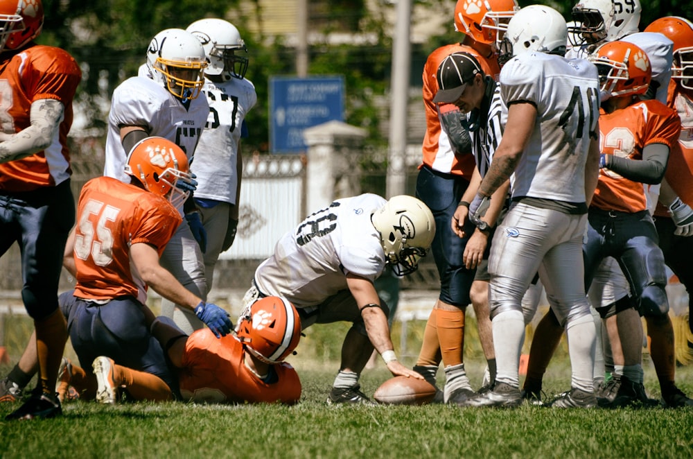 a group of football players standing on top of a field