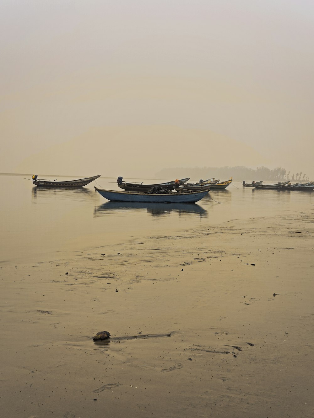 a group of boats floating on top of a lake