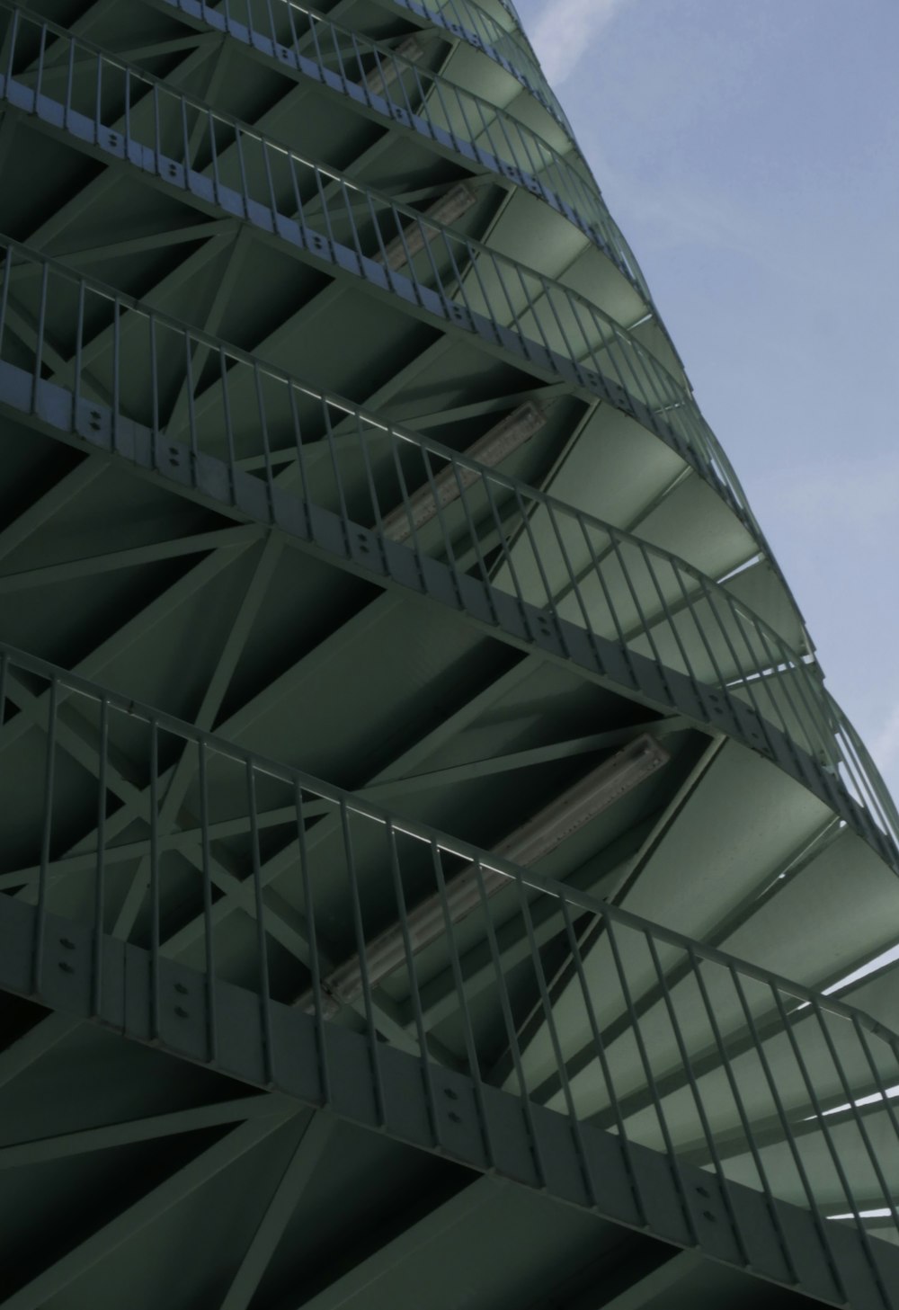 a tall green building with a clock on it's side