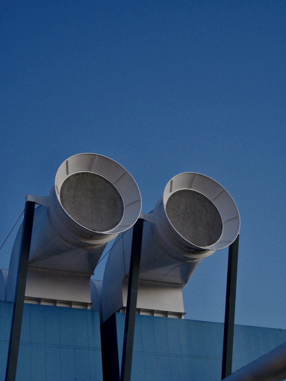 a couple of large metal objects on top of a building