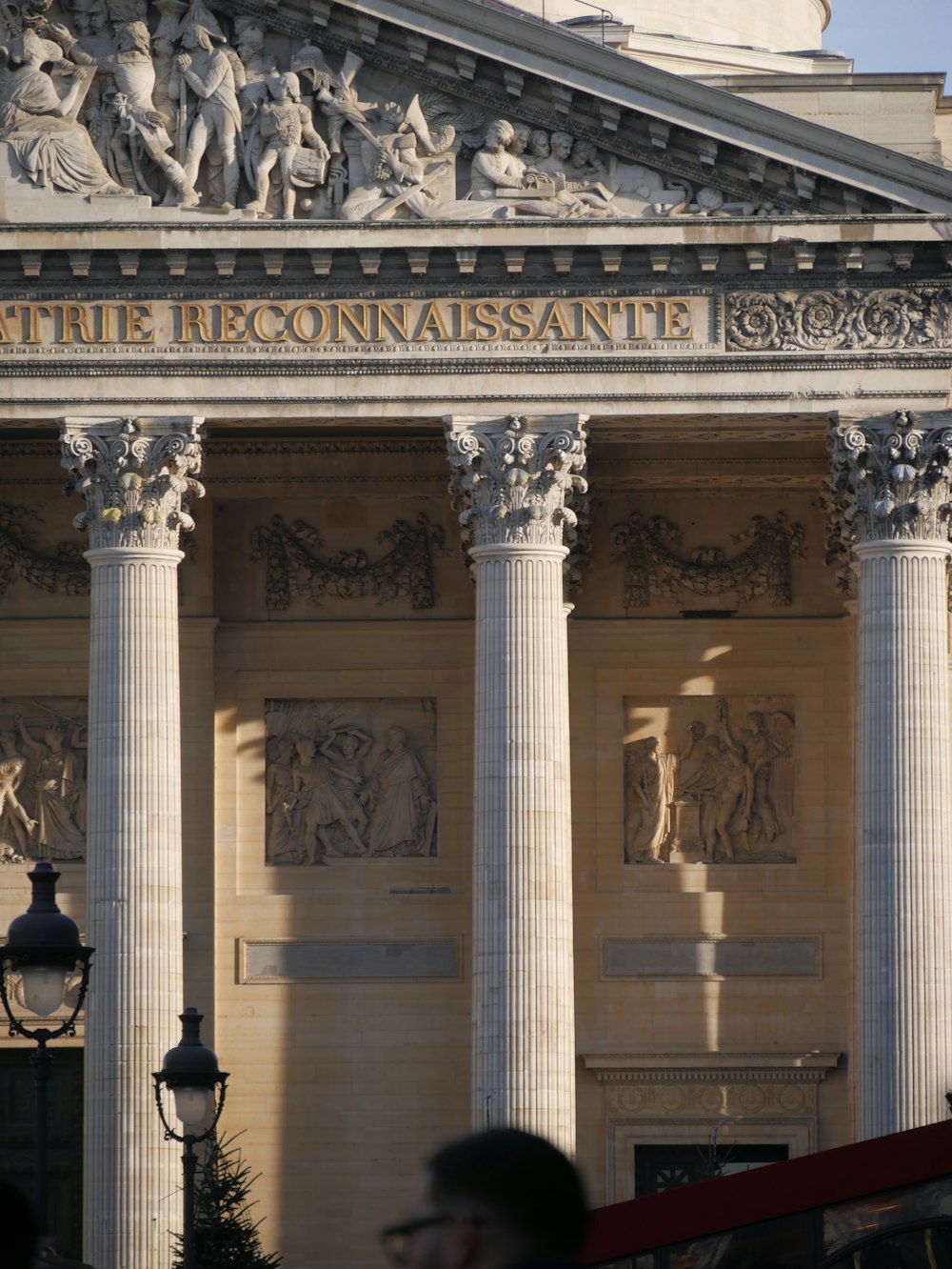 a large building with columns and statues on it