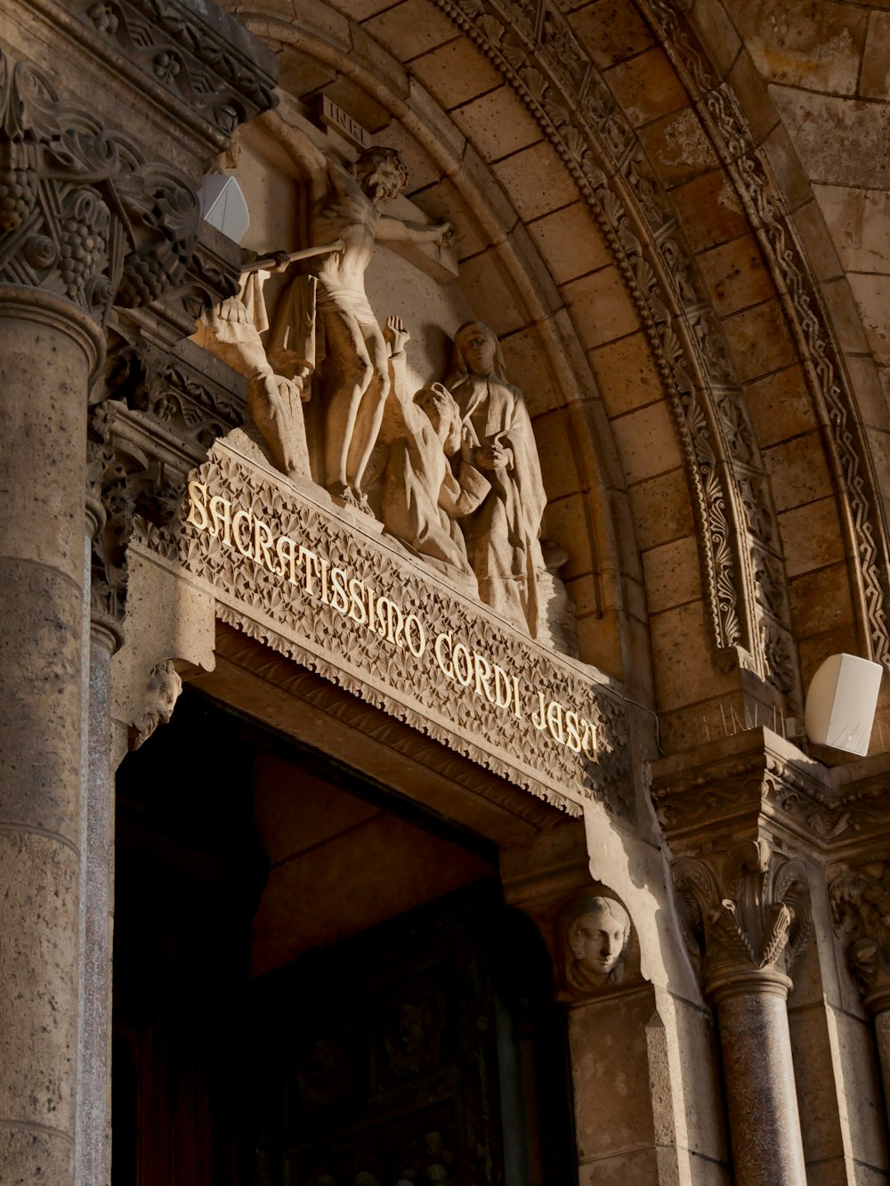 a large building with a statue on the front of it