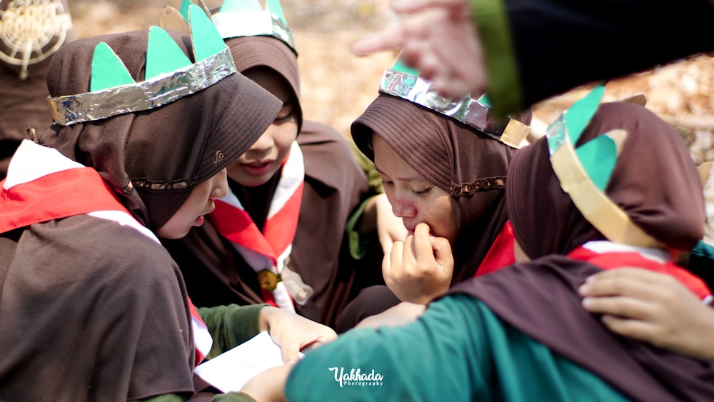 a group of people wearing crowns on top of each other