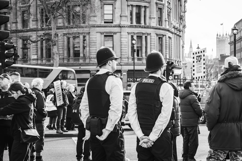 a group of people standing on the side of a road