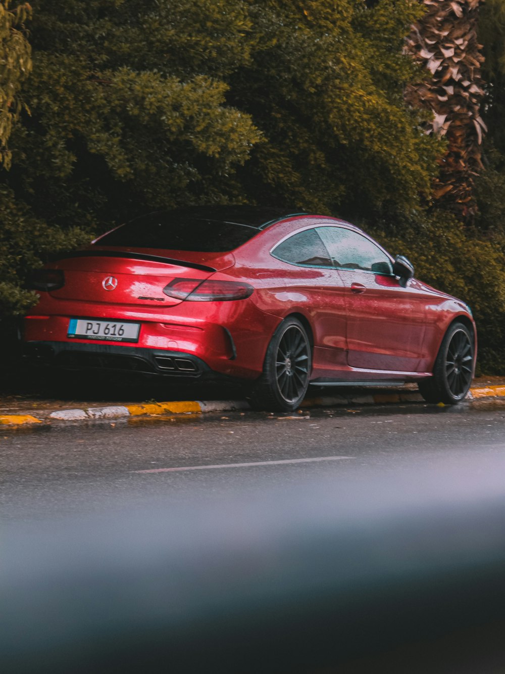 a red car parked on the side of the road