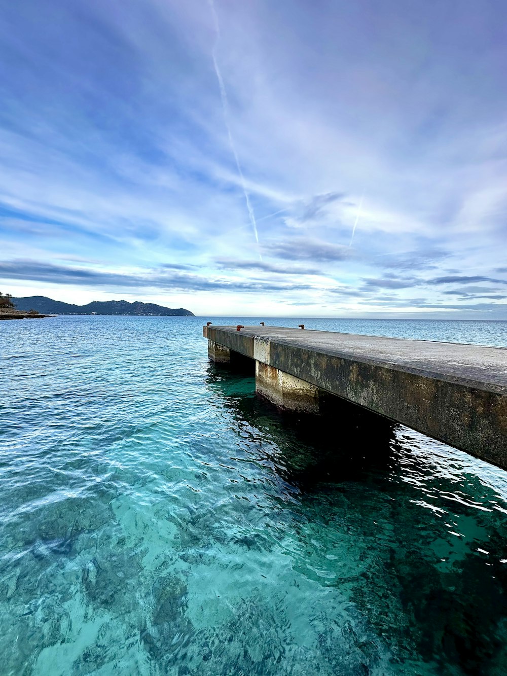 a long pier extending out into the ocean