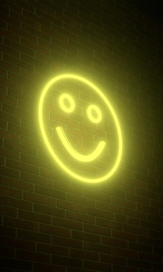 a smiley face neon sign on a brick wall