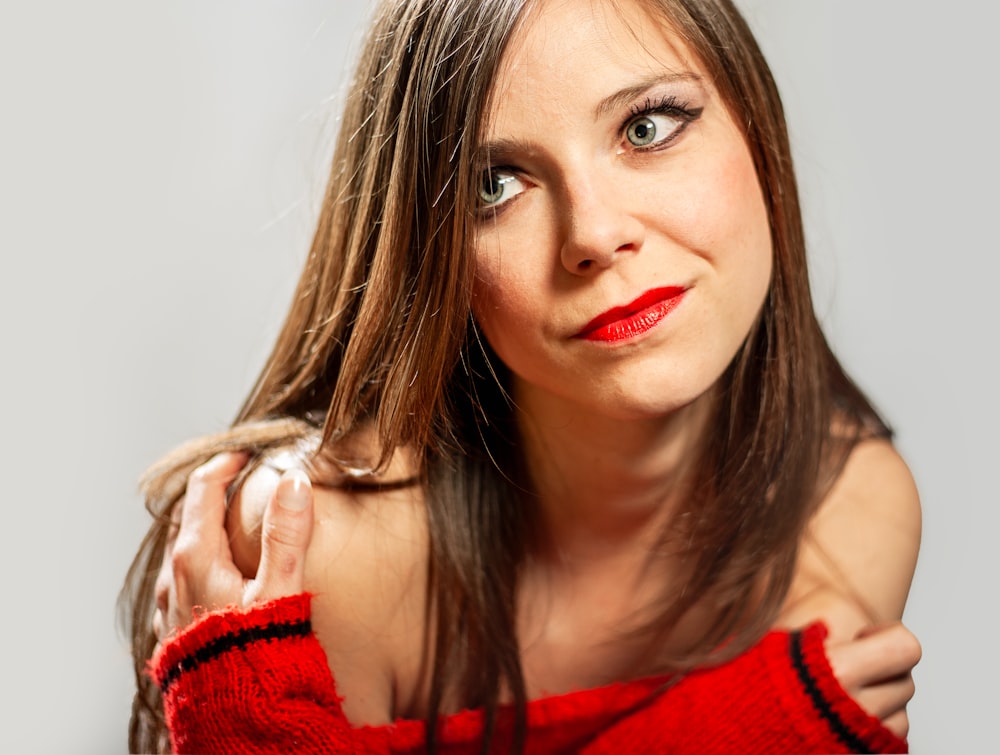 a woman in a red sweater posing for a picture
