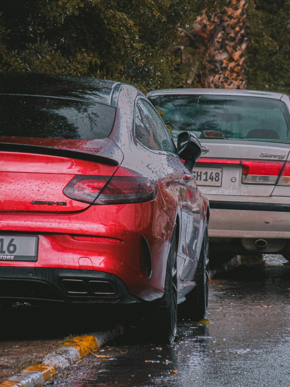 a couple of cars parked next to each other on a street