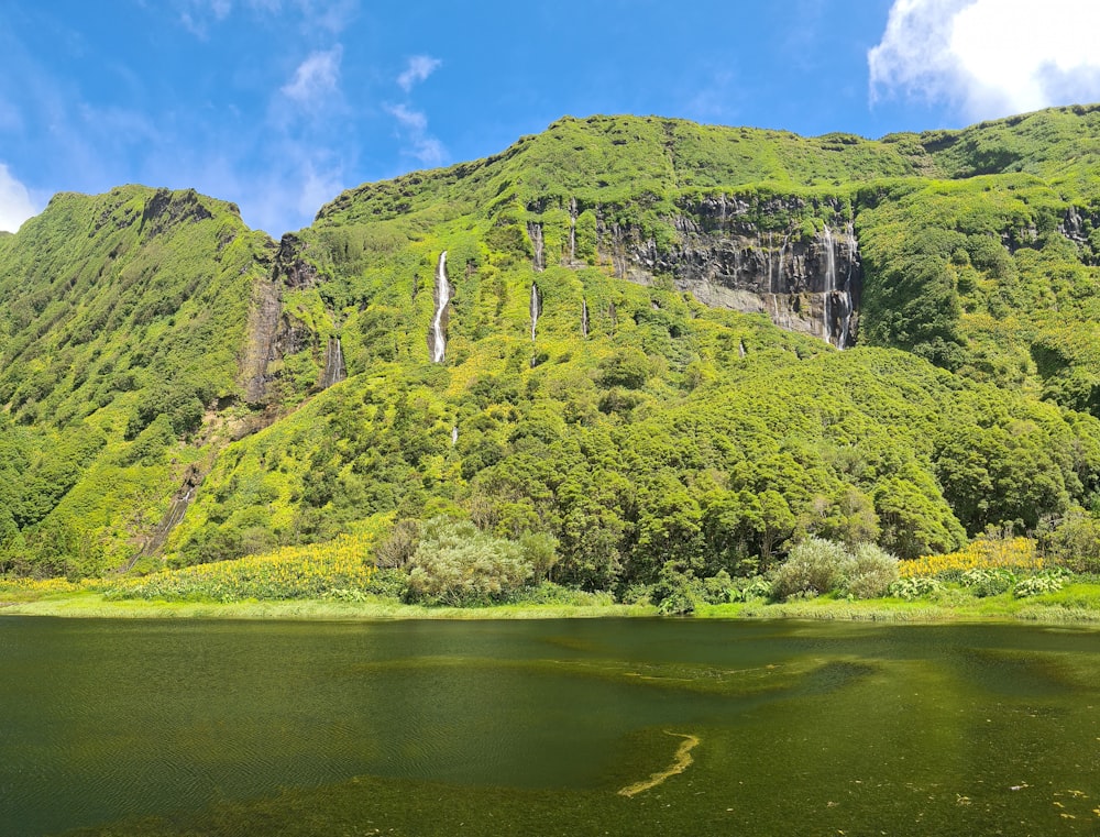 a mountain with a body of water in front of it