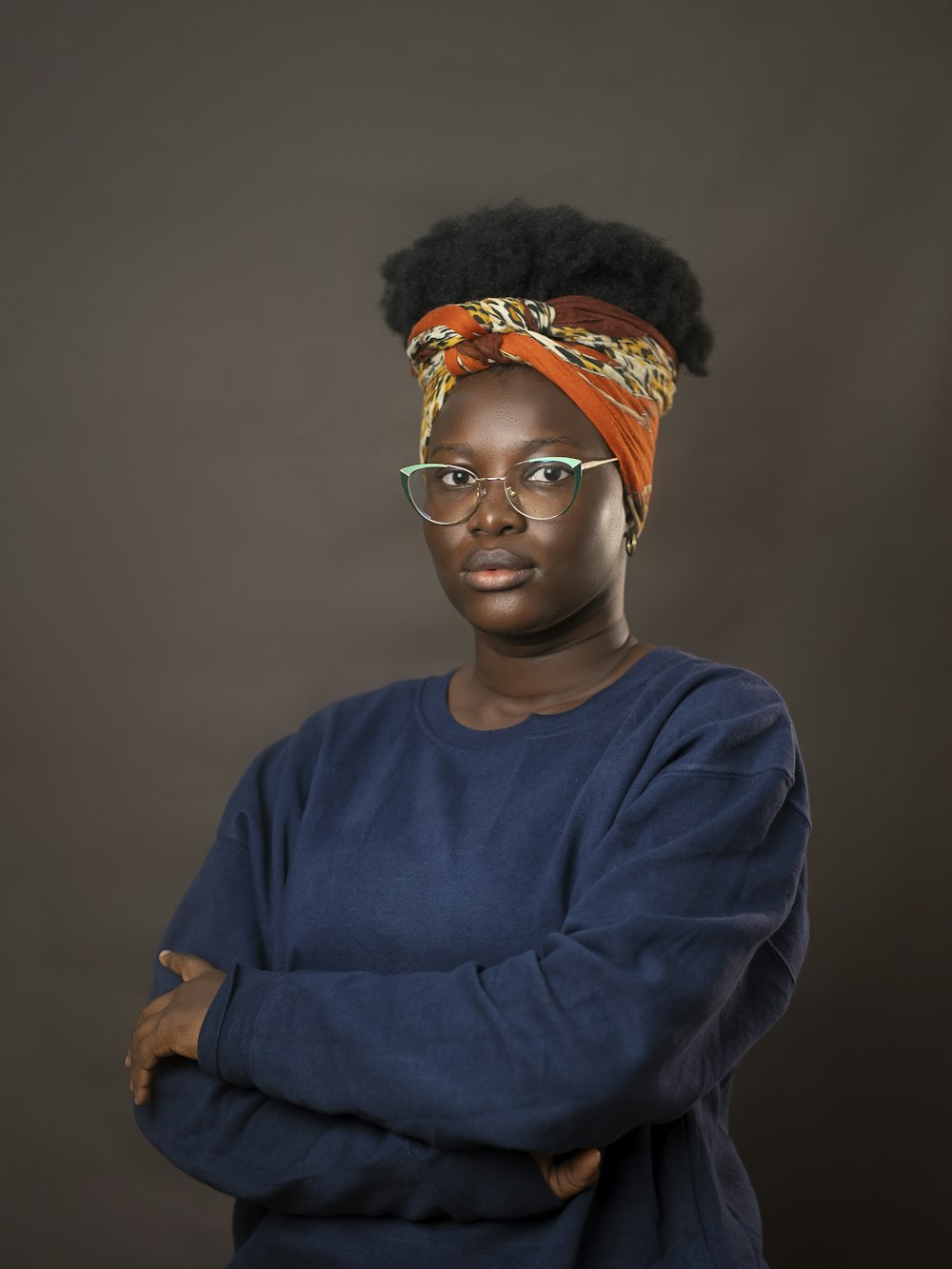 a woman wearing glasses and a head scarf