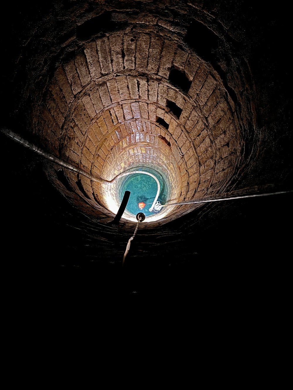 a man standing in the middle of a tunnel